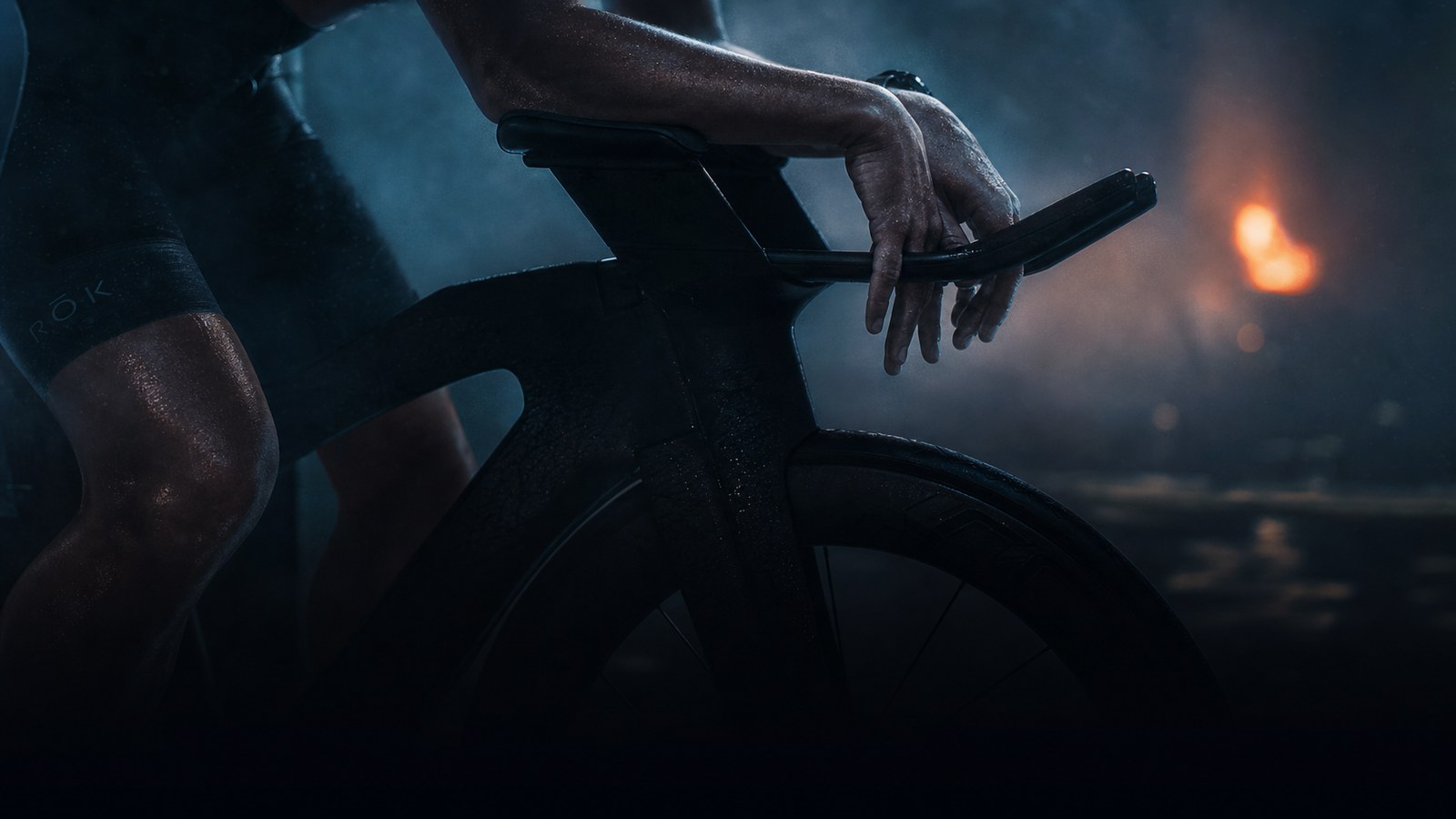 A triathlon bike's aero-bars in low light: the taper is a controlled reduction of load, not rest