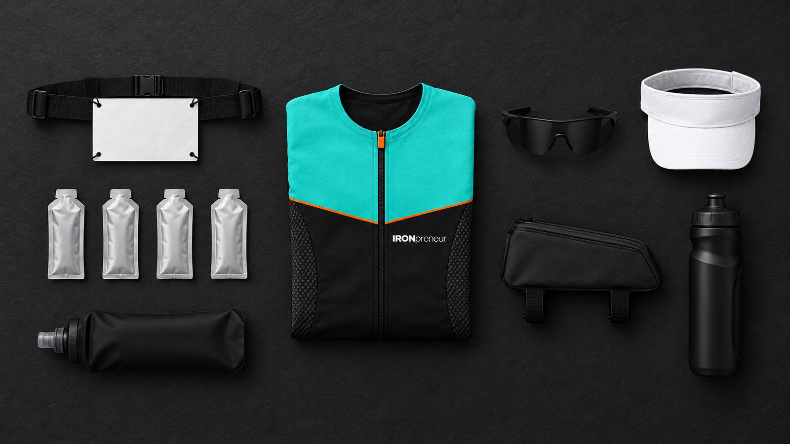 Concept render: flat lay of the folded Dark Force suit with a race belt, four unbranded gels, a soft flask, a top-tube bento bag, a bottle, sunglasses and a white visor.
